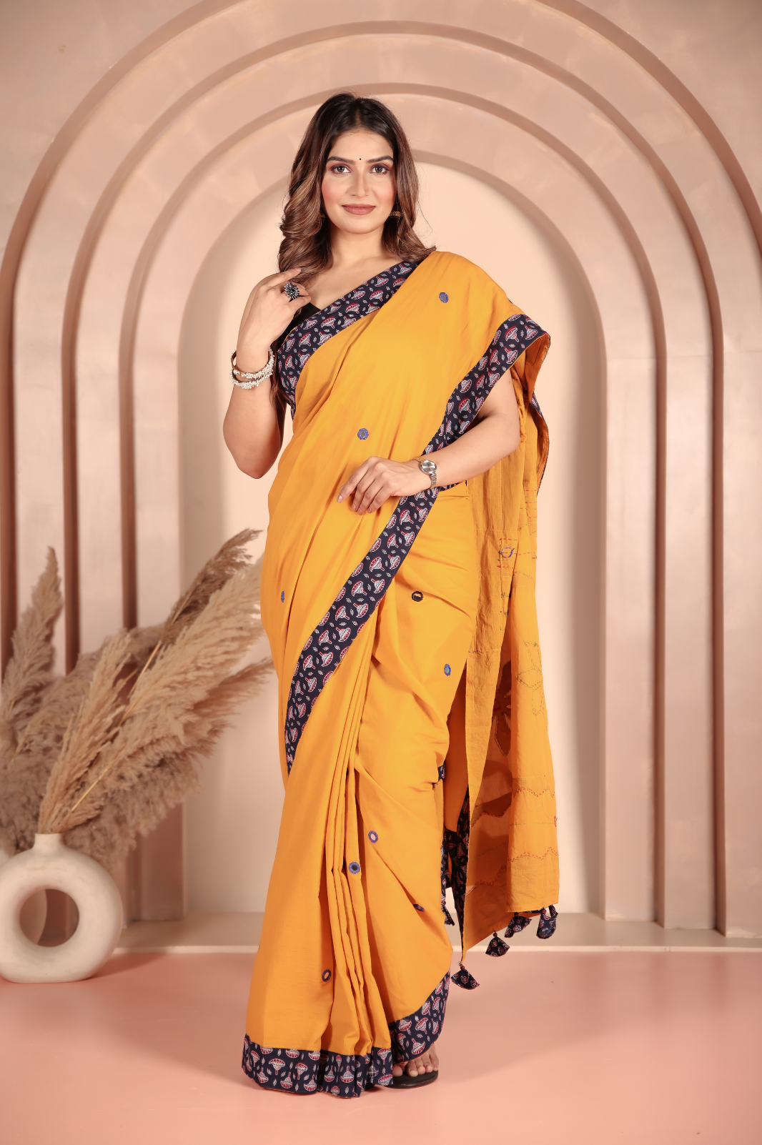 Mustard yellow saree features intricate applique work