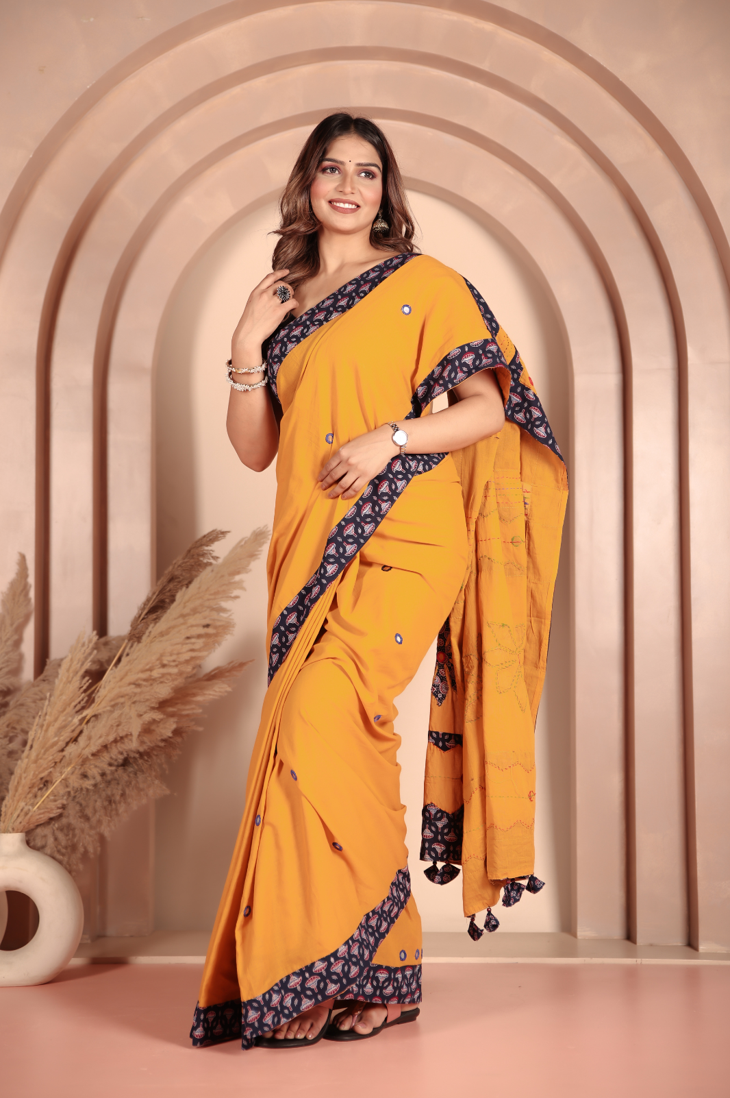 Mustard yellow saree features intricate applique work