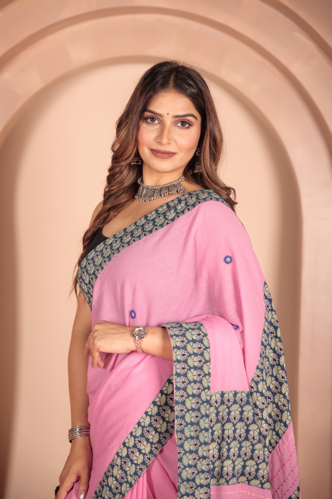 Pink saree features intricate cotton applique work