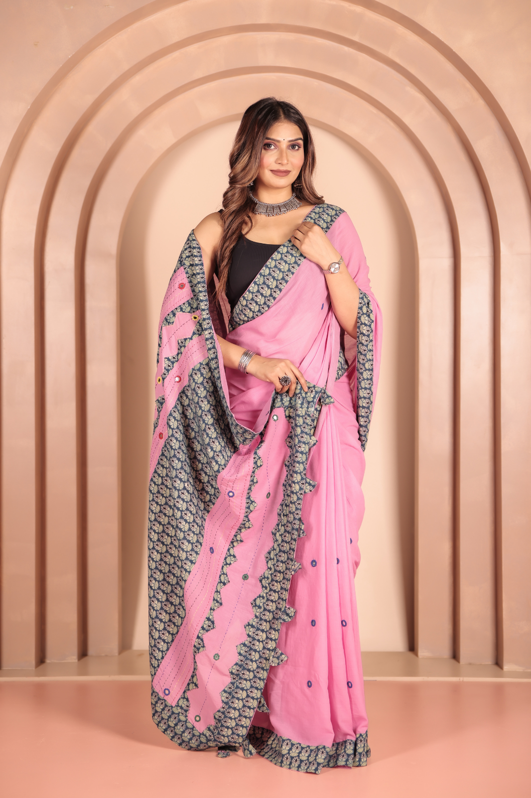 Pink saree features intricate cotton applique work