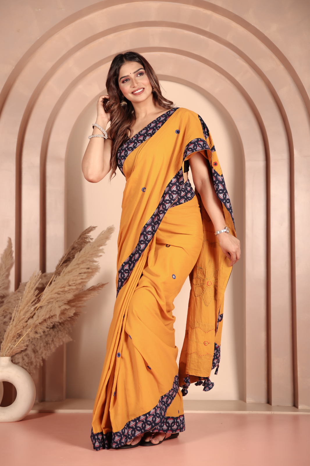 Mustard yellow saree features intricate applique work