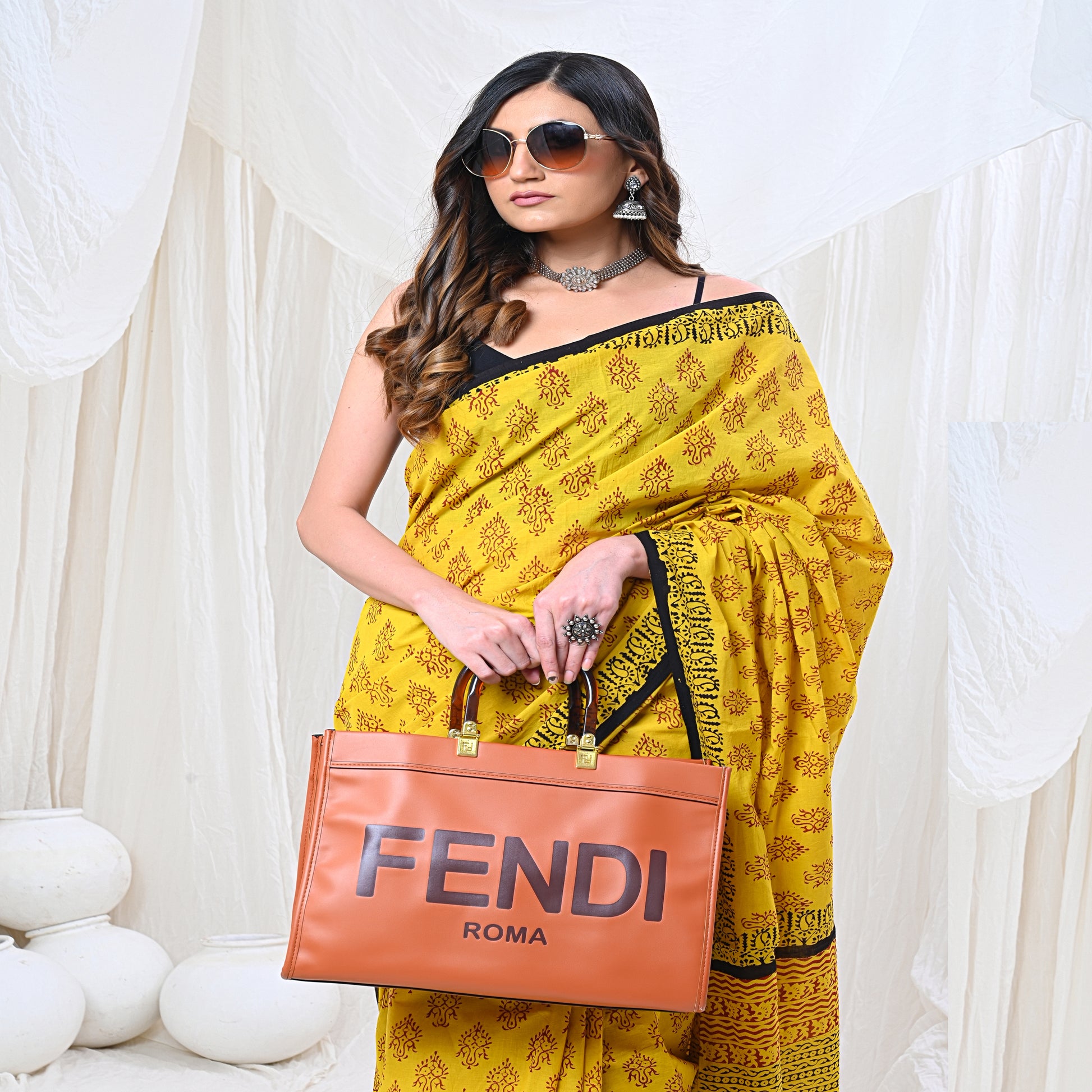 Traditional Indian cotton saree in vibrant yellow color, featuring intricate floral patterns