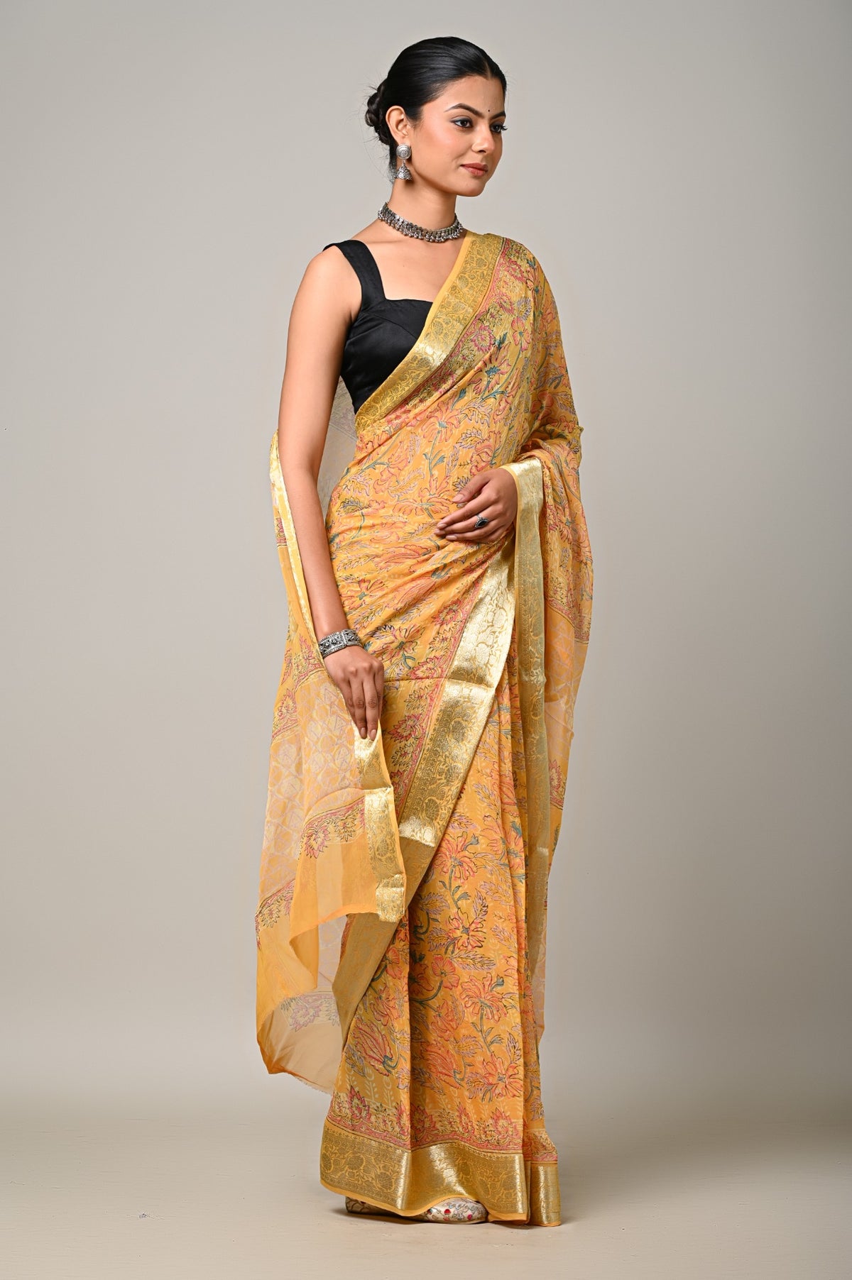 Sunlit Gulmohar chiffon saree side view with golden zari border