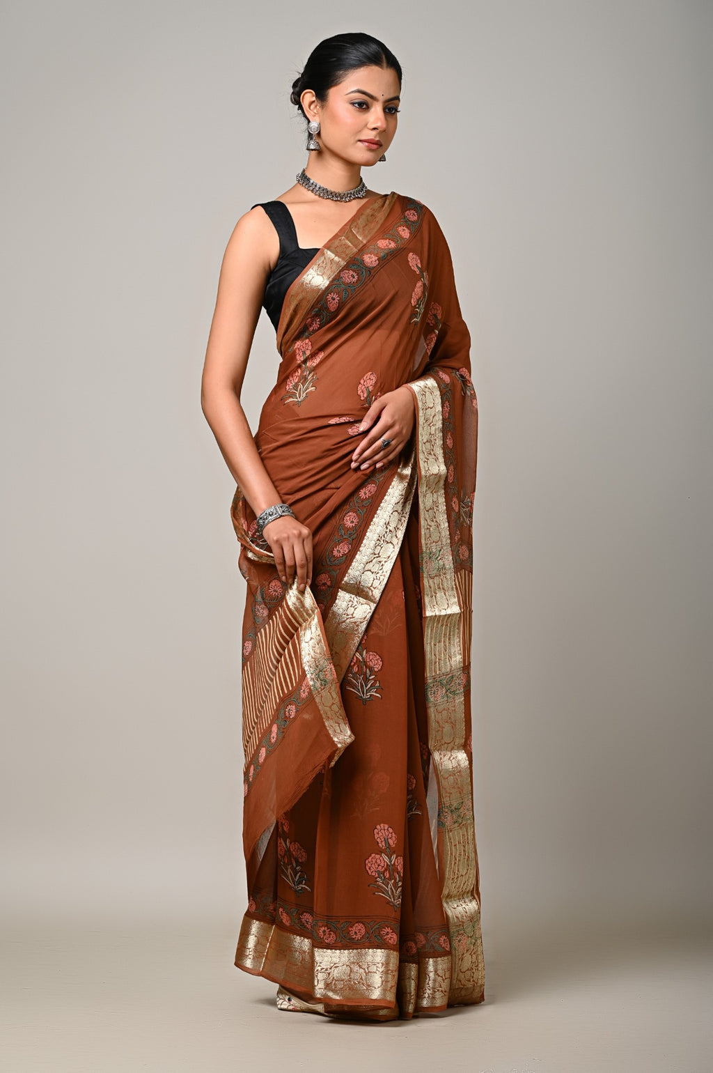 Rust brown handblock printed chiffon saree with floral motifs and metallic border